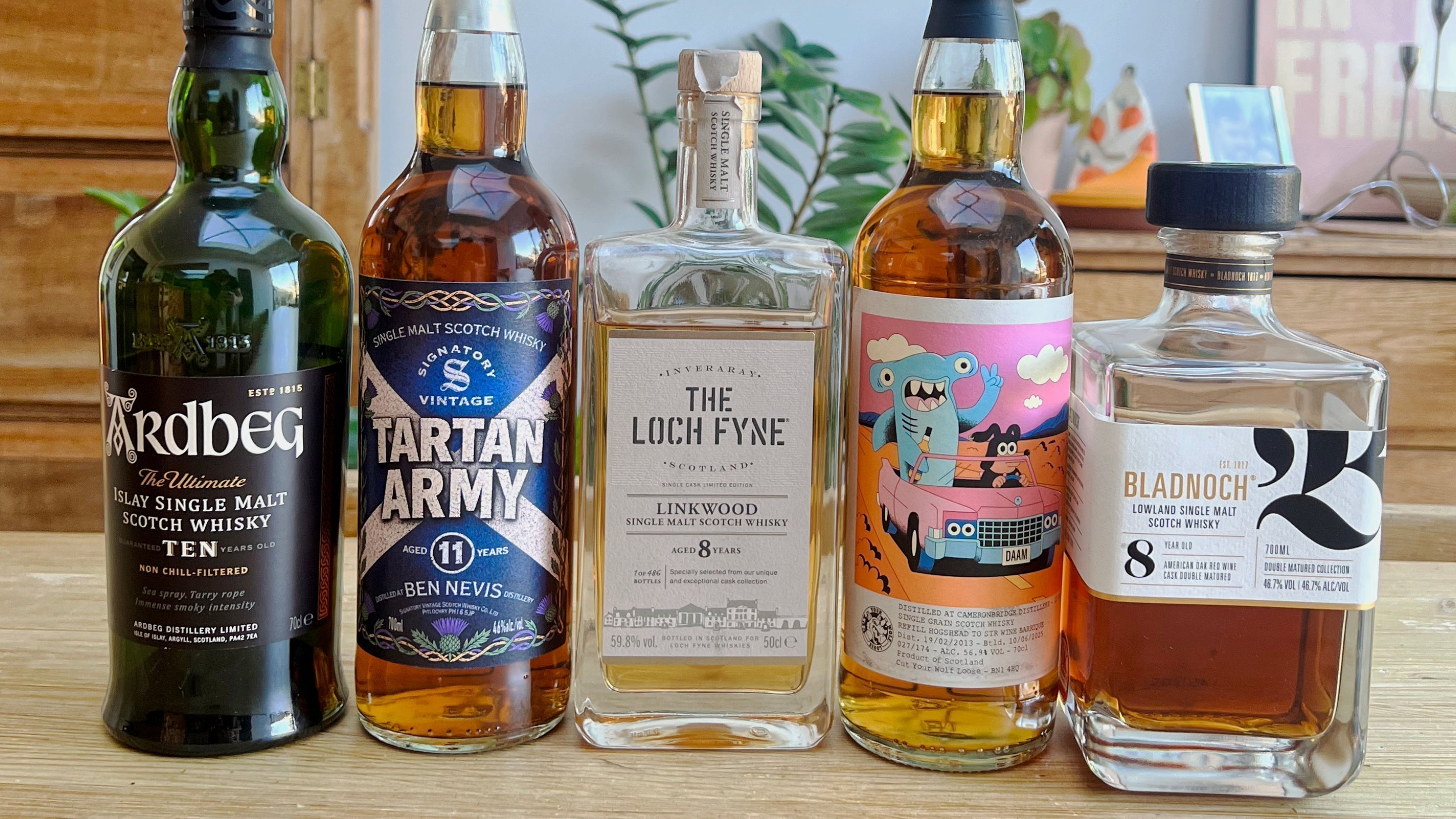 Devon Dram Club members enjoying a blind whisky tasting in Exeter featuring five Scotch whiskies.